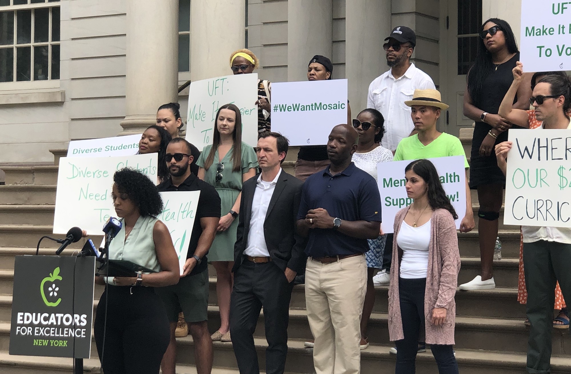 Background Image: E4E teachers and staff on the steps of New York City Hall delivering a press conference.